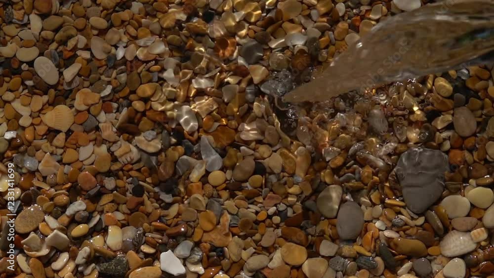 Slow motion of jet waterfall and splash on pebble beach with shallow water background close up. Amazing natural vacation scene with vibrant texture in sun shine.
Slow motion of jet waterfall and splash on pebble beach with shallow water background close up. Amazing natural vacation scene with vibrant texture in sun shine.