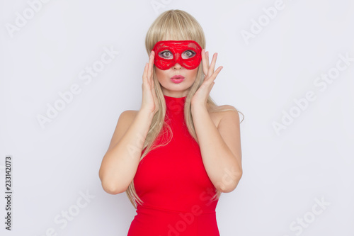 Woman in red dress put carnival mask over white background