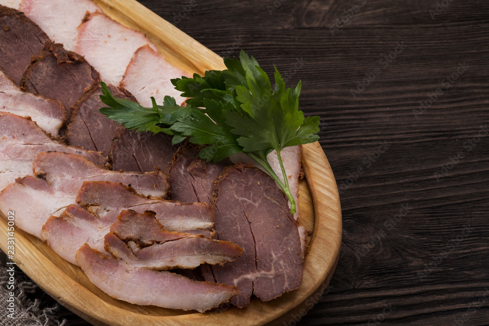 Delicious smoked pork fillet, veal fillet and pork brisket on wooden board. Cold meat snack. Copyspace Delicious smoked pork fillet, veal fillet and pork brisket on wooden board. Cold meat snack. Copyspace