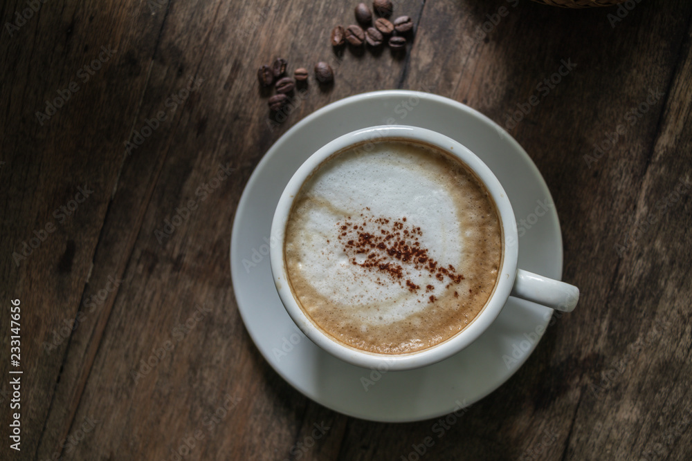 A cup of coffee in the wooden table. A cup of coffee in the wooden table.