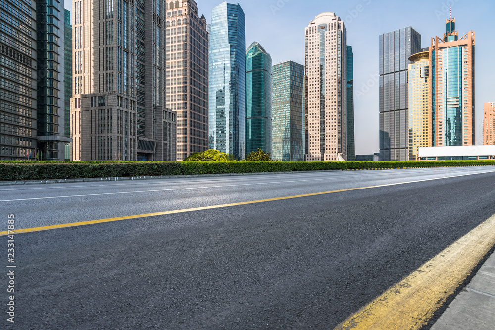 cityscape and skyline of shanghai from empty asphalt road.