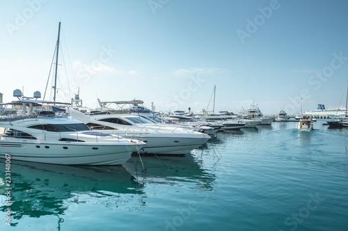 small boats and yachts are in the berth of the seaport of Sochi on the Black sea bright sunny summer day