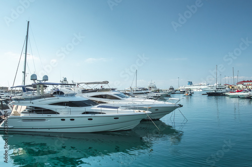 small boats and yachts are in the berth of the seaport of Sochi on the Black sea bright sunny summer day