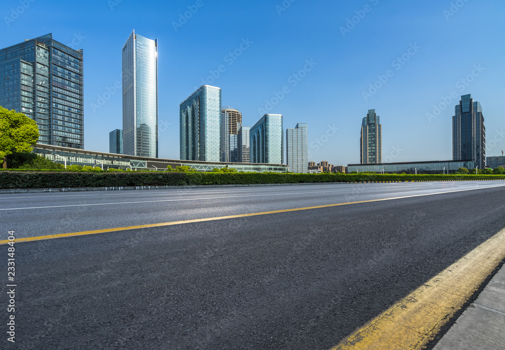 city empty traffic road with cityscape in background