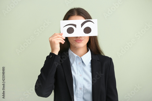 Emotional young woman hidin...