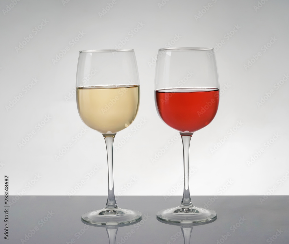 Glasses of expensive red and white wines on table Glasses of expensive red and white wines on table