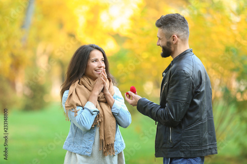 Young man proposing to his ...