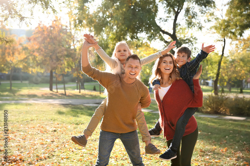 Happy family in autumn park