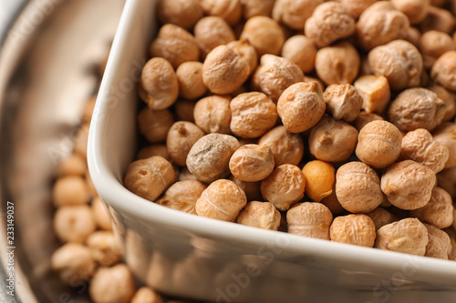 Bowl with dry chickpeas, closeup
