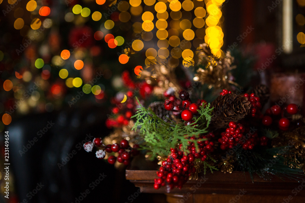Details of the scenery of the new year. Red berries, Christmas lights, gifts, festive table setting in the light of lights garlands and home decorations. - obrazy, fototapety, plakaty 