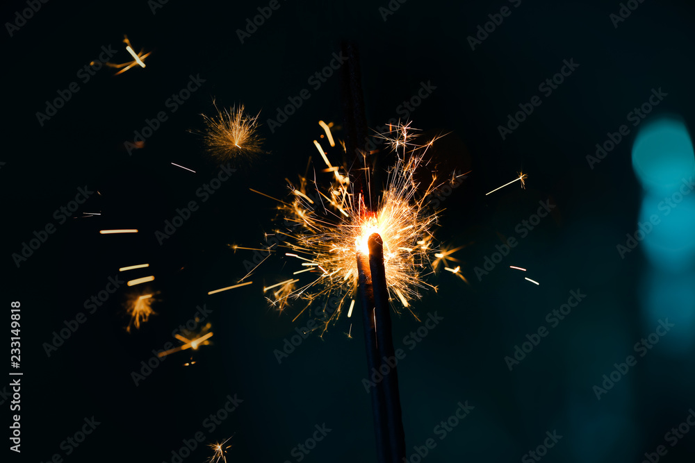 Fototapeta premium Festive Christmas sparklers on dark color background