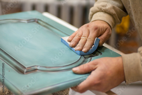 Painting wooden parts. Painting chamber, spray gun. Furniture manufacture.