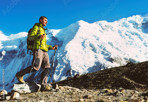 Happy hiker walking in the mountains, freedom and happiness, achievement in mountains.