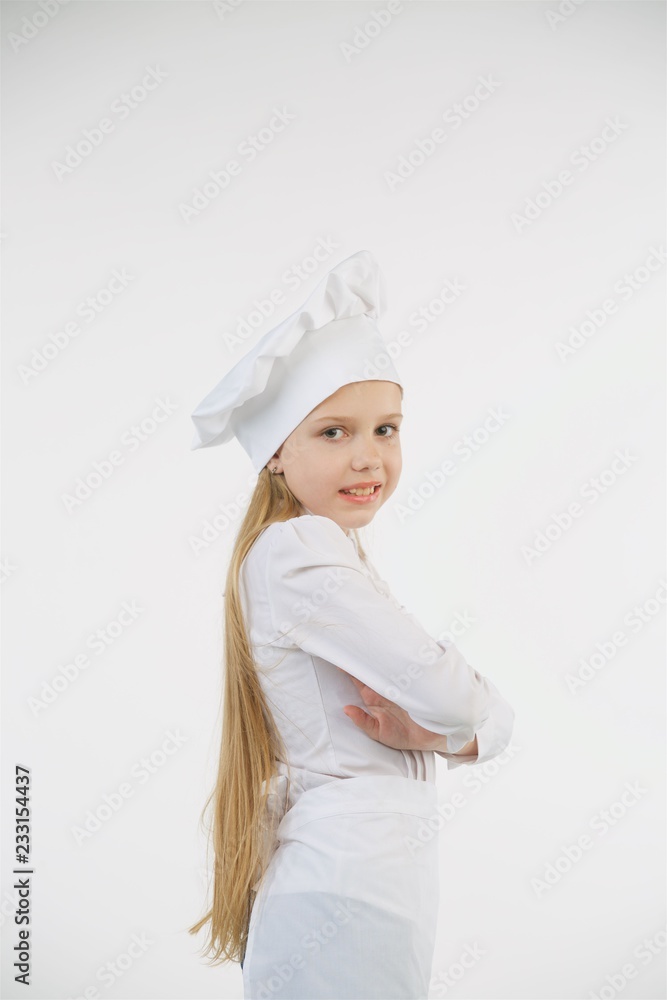 School-age girl dressed as a cook in white. School-age girl dressed as a cook in white.