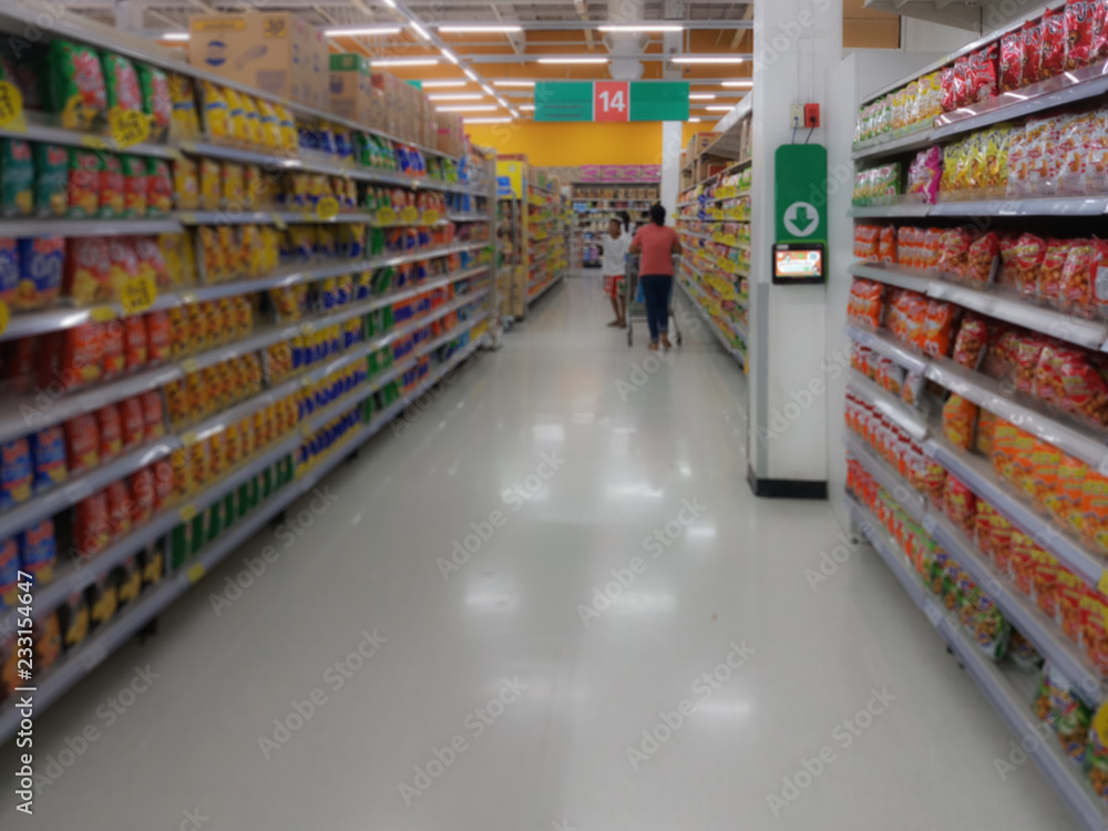 Blurred people shopping in selection of Snack on shelf in supermarket or department store, products on shelves