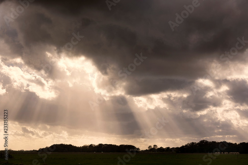 View on a dramatic and beautiful cloudscape on the island of Texel, province North-Holland, the Netherlands. It was a stormy and rainy evening in autumn with impressive clouds and sunlight in the sky 