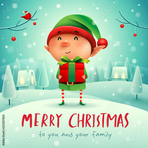 Merry Christmas! Little elf with gift present in Christmas snow scene winter landscape.
