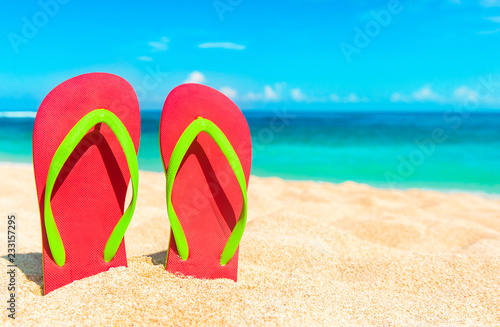 Beach sandals on the sandy coast. Summer holiday and vacation concept.