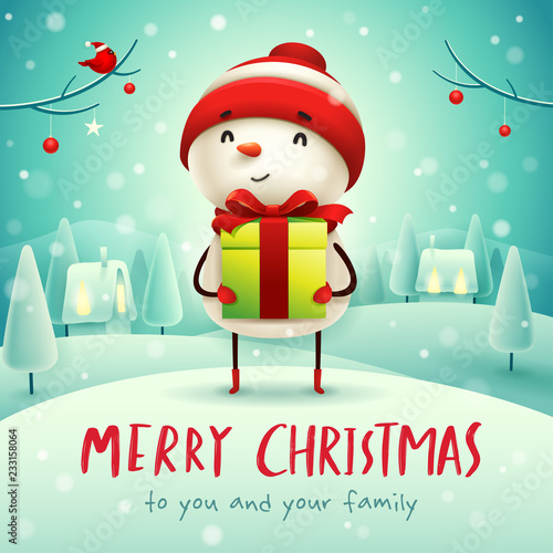 Merry Christmas! Cheerful snowman with gift present in Christmas snow scene winter landscape.