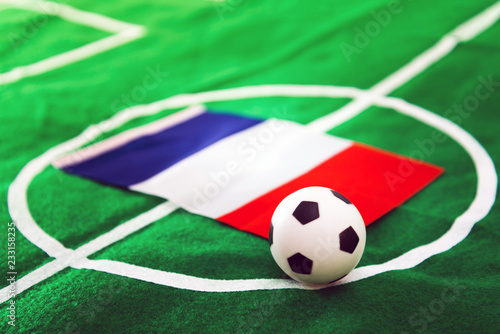France flag and soccer ball on green grass field