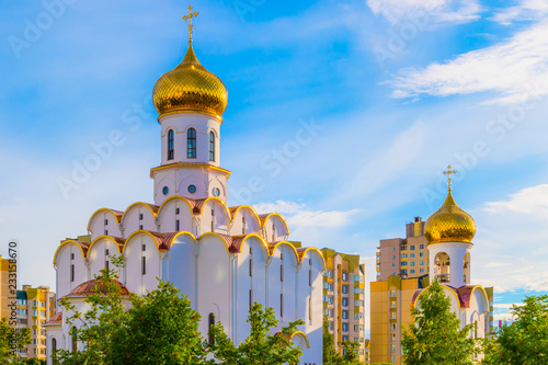 Gold domes of Temple of Archangel Michael on background of blue sky. Minsk, Belarus