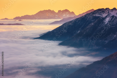 Amazing sunset in Alps mountains over cloud and mountain ridge in sunlight, Hohe Tauern national park, Carinthia, Austria