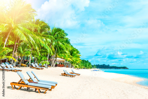 Beautiful beach. Chairs on the sandy beach near the sea. Summer holiday and vacation concept.