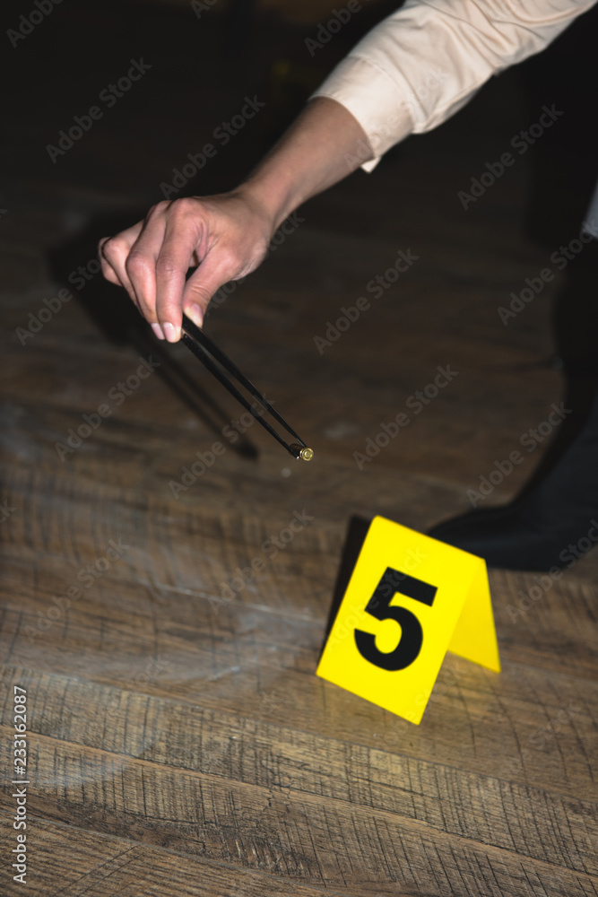 cropped view of hand examining evidence at crime scene Stock Photo ...