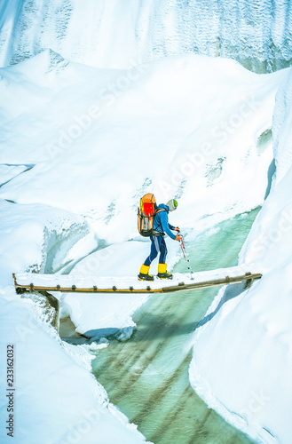 Slika na platnu Mountaineer with backpack crossing Khumbu glacier crevasse during ascent on Ever