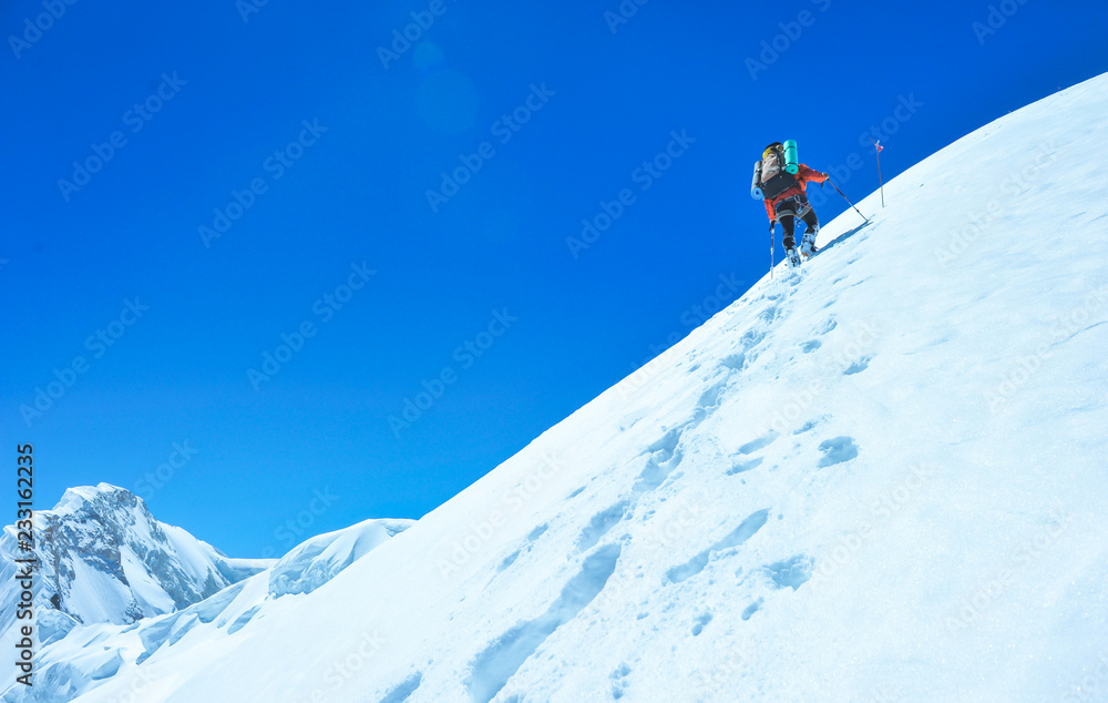 A climber reaching the summit of the mountain. Active sport concept