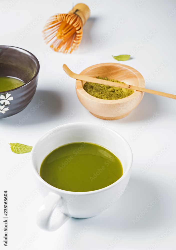 Green matcha tea in the cup on the white background Green matcha tea in the cup on the white background