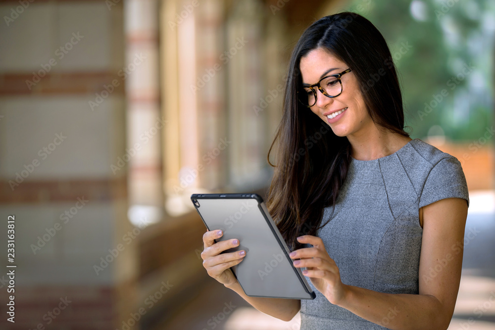 Fototapeta premium Close up of beautiful female executive business professional, working on computer tablet