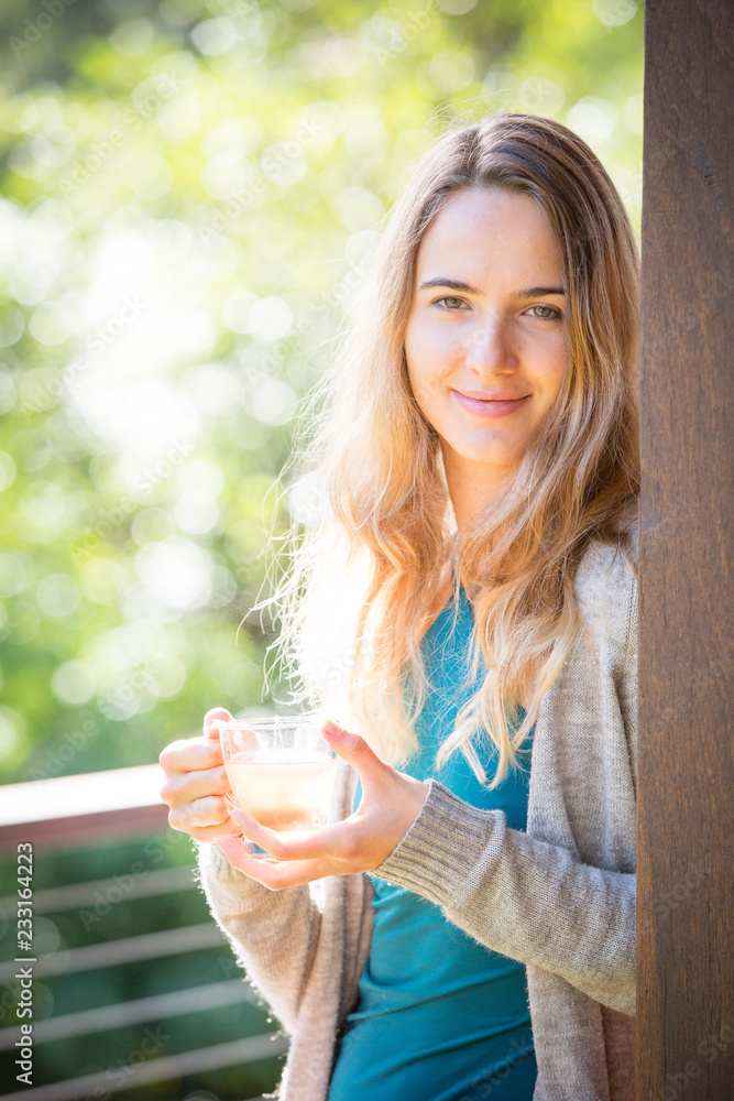 Young woman drinking herbal tea outdoors Young woman drinking herbal tea outdoors