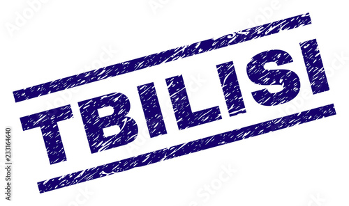 TBILISI seal print with distress style. Blue vector rubber print of TBILISI caption with corroded texture. Text caption is placed between parallel lines.