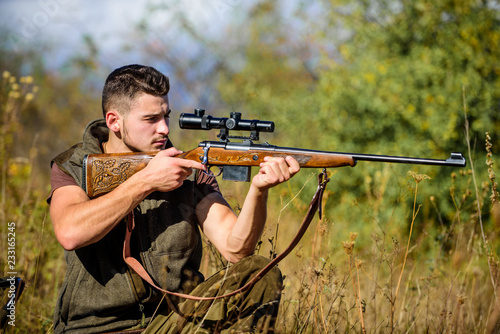 Hunting weapon gun or rifle. Hunting target. Looking at target through sniper scope. Man hunter aiming rifle nature background. Hunting skills and weapon equipment. Guy hunting nature environment