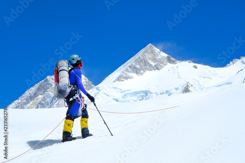 Climber reache the summit of mountain peak. Climber on the glacier. Success, freedom and happiness, achievement in mountains. Climbing sport concept.