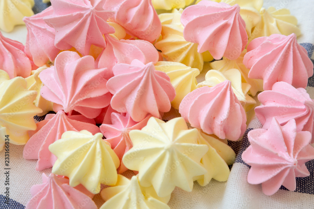 Mini meringues on striped napkin, side view. Close-up. Mini meringues on striped napkin, side view. Close-up.