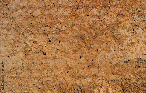 Dry soil texture and background. Brown soil background. Abstract ground. Natural abstraction. Cracked soil background. Clay. Ocher