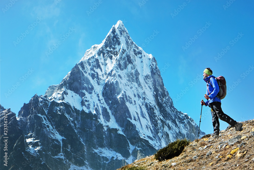 Hiker with backpacks in Himalayas mountain, Nepal. Active sport concept.