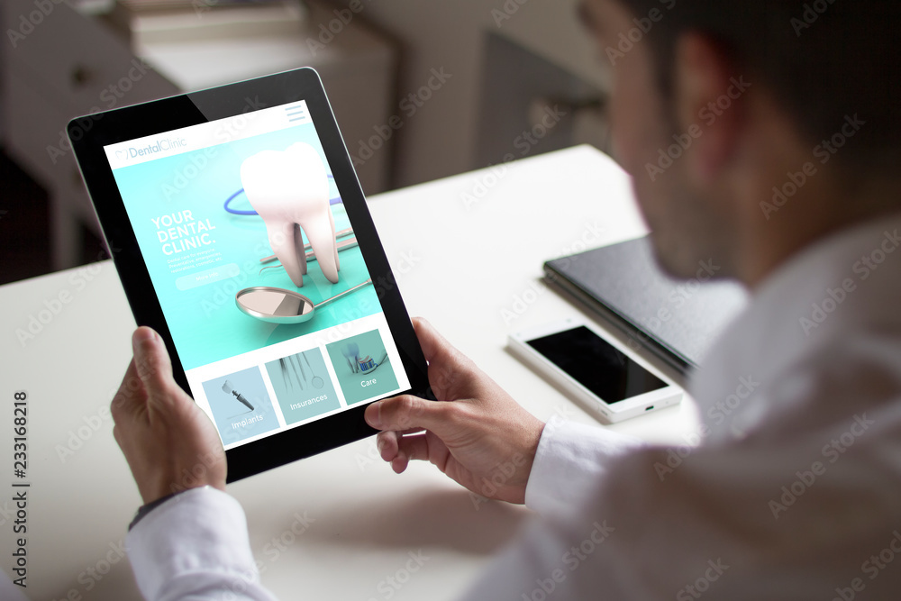 businessman dental clinic website with tablet pc businessman dental clinic website with tablet pc