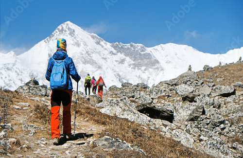 Young woman hiker enjoy the trek to Everest Base Camp. Success, freedom and happiness, achievement in mountains. Active sport concept. Cho Oyu view