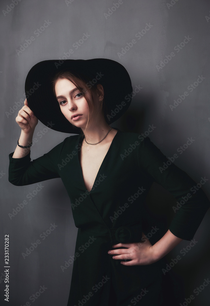 Beautiful, young girl in a stylish felt hat with wide brim sad and nostalgic Beautiful, young girl in a stylish felt hat with wide brim sad and nostalgic