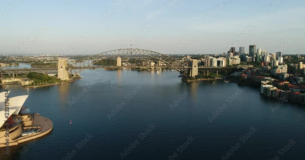 Sydney harbour between North shore and Sydney city CBD waterfront connected by the Sydney harbour bridge in aerial hovering.
Sydney harbour between North shore and Sydney city CBD waterfront connected by the Sydney harbour bridge in aerial hovering.