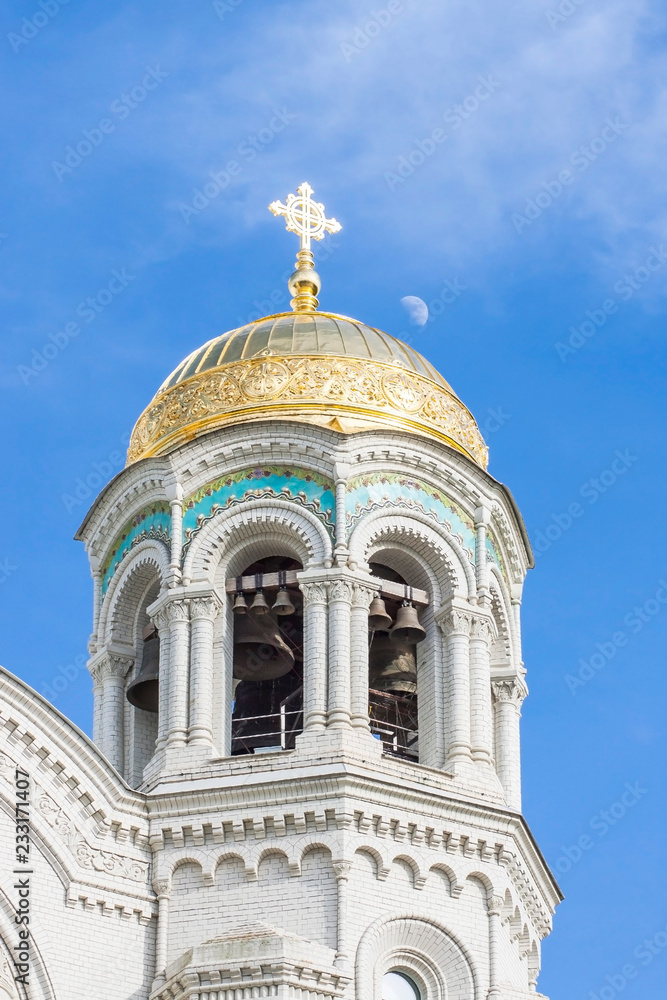 bell tower of St. Nicholas Cathedral in Kronstadt,  Golden domes in the blue sky 