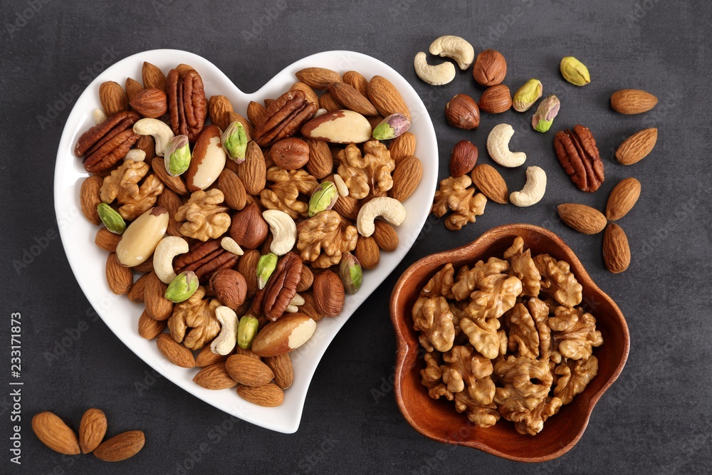 Fototapeta premium Nuts on a plate in the shape of a heart.