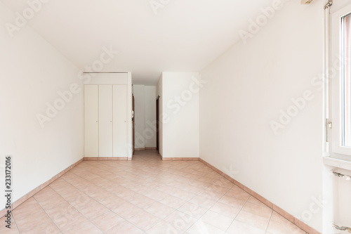 Front view of empty room with wardrobe