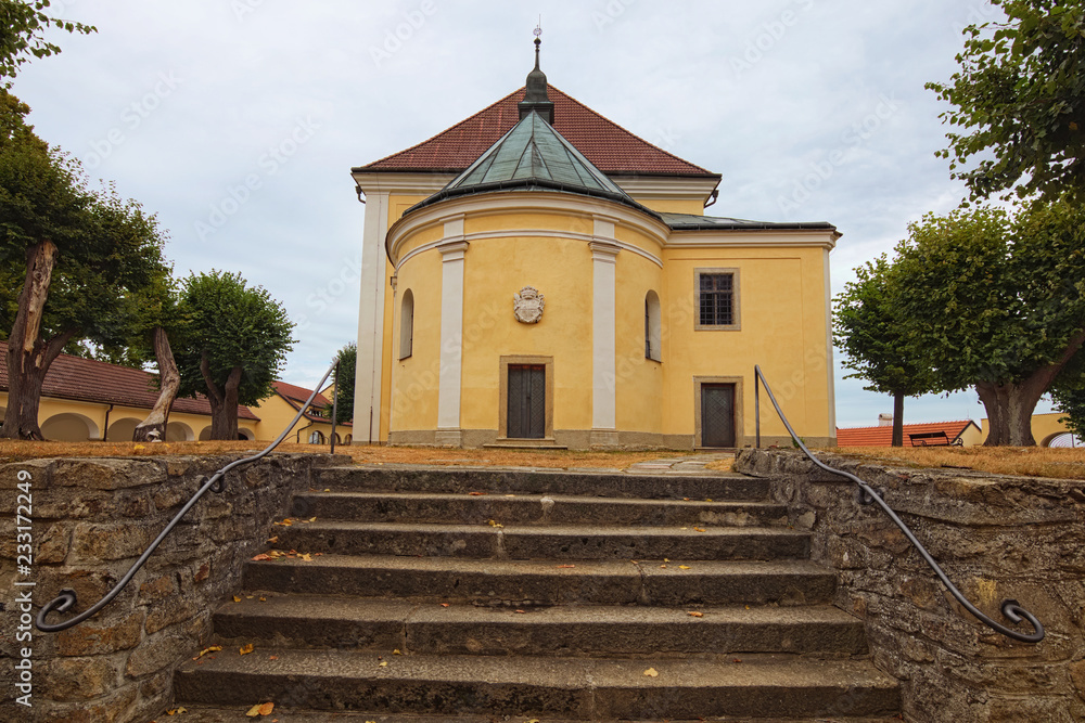 Obraz premium Landscape view of medieval Church of Our Lady of Carmel in Kostelni Vydri village in cloudy summer day. South Bohemian Region, Czech Republic