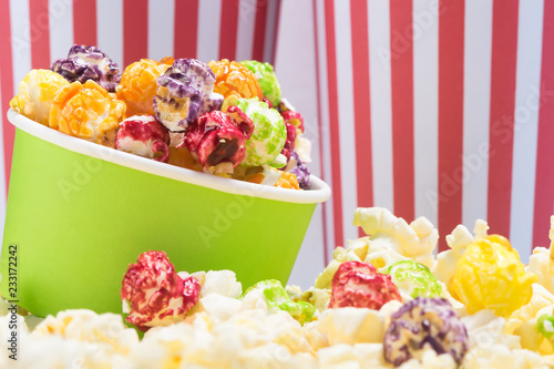 paper cup with multicolored sweet popcorn, beautiful background for an inscription