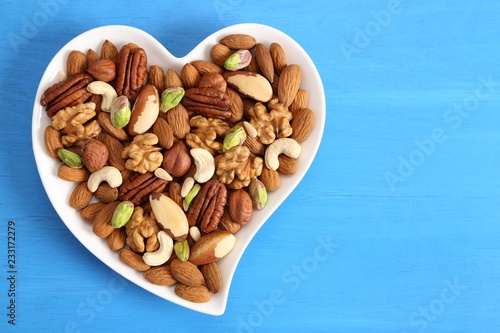 Nuts on a plate in the shape of a heart.