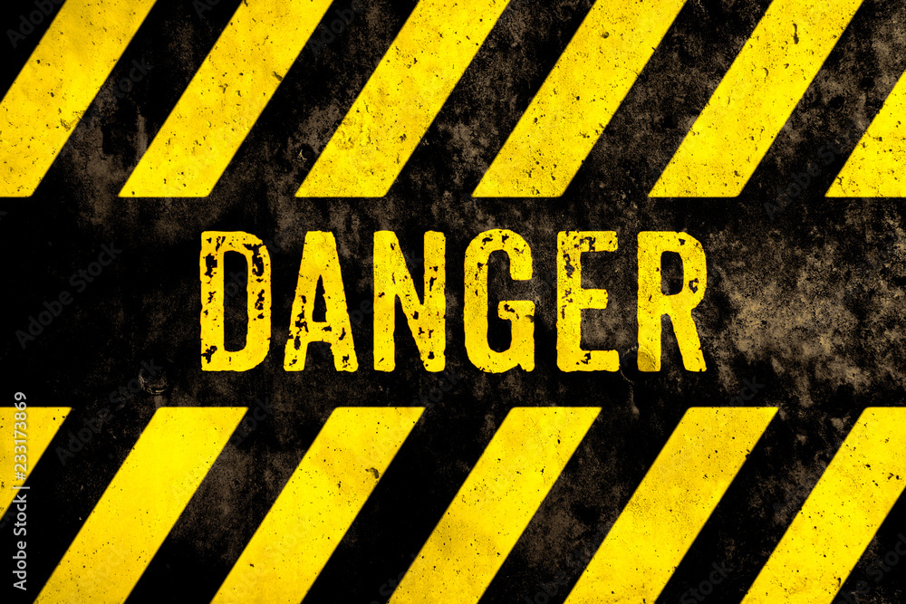 Danger warning sign text with yellow and black stripes painted over